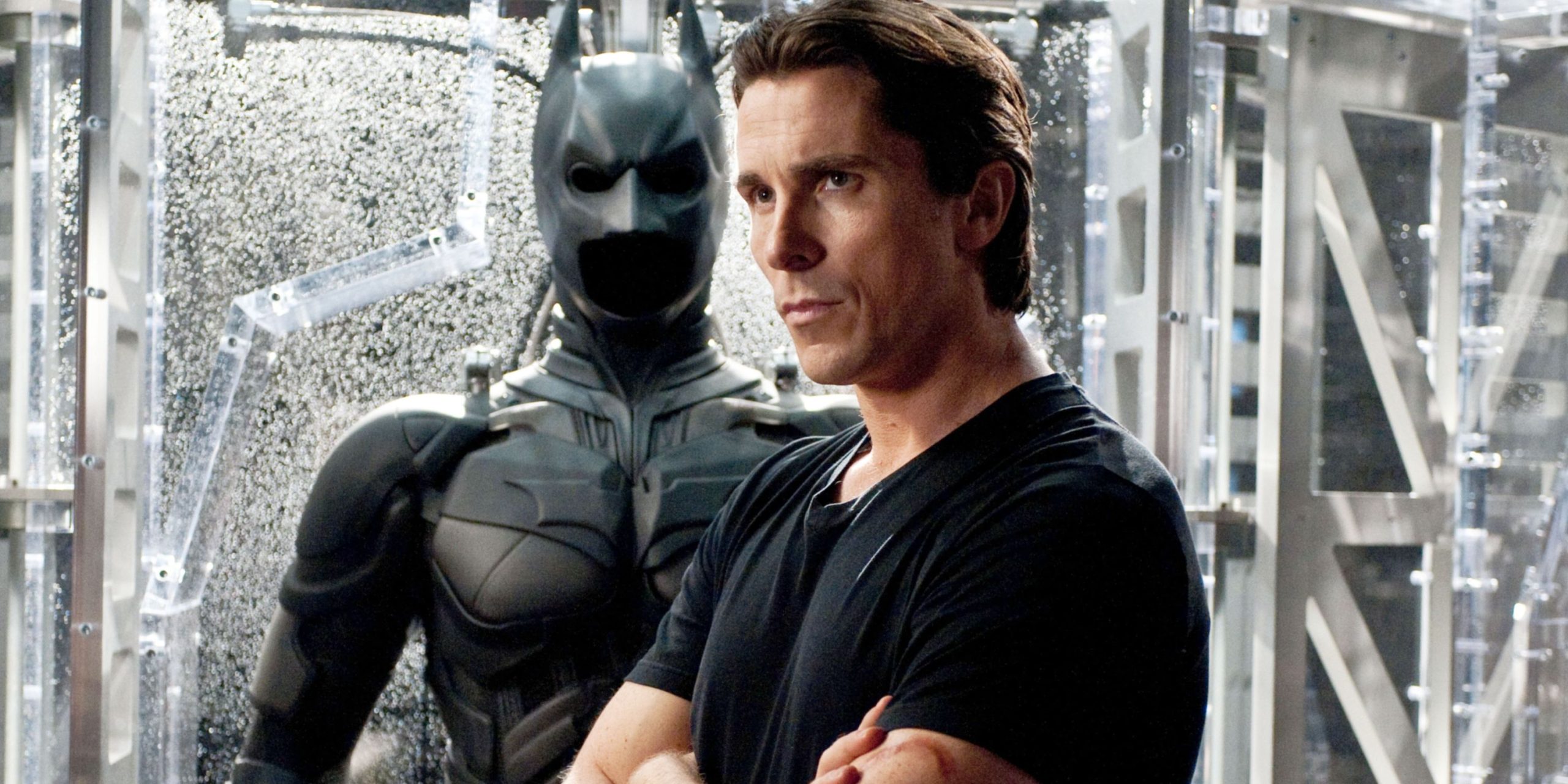 christian-bale-stood-in-front-of-the-batman-suit-in-the-dark-knight-rises.jpg