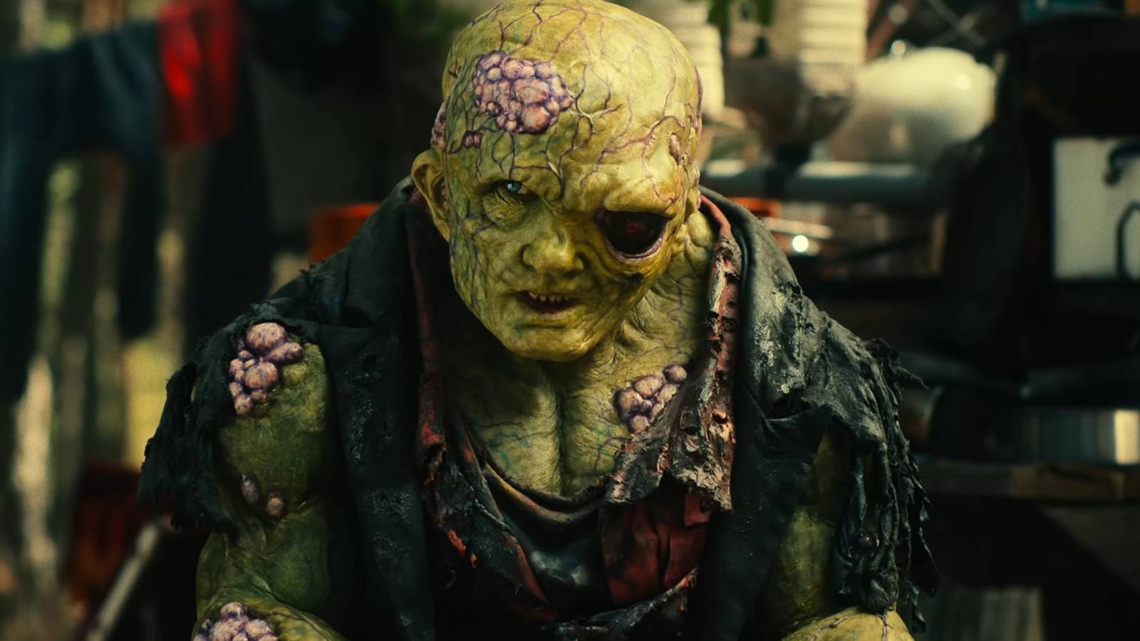 The Toxic Avenger Remake: 10 Goriest Moments Ranked toxie-looking-suspiciously-while-sitting-in-a-junkyard-in-toxic-avenger-2025.jpg