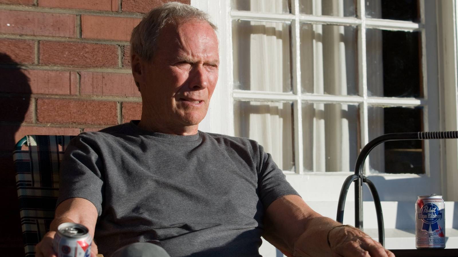 clint-eastwood-sits-on-a-porch-in-gran-torino.jpg