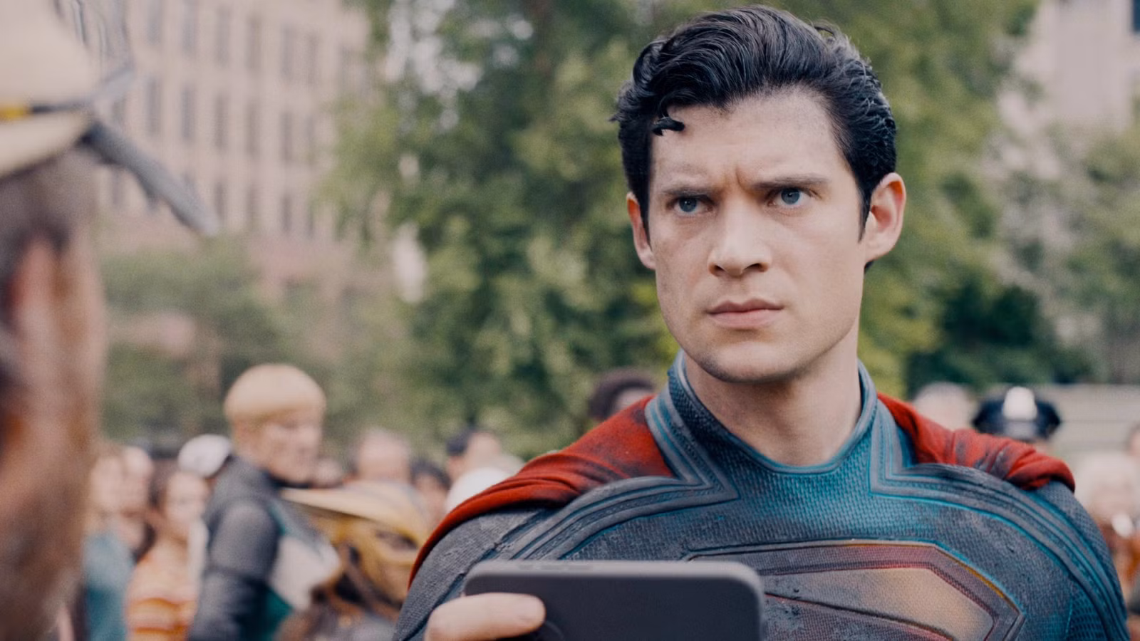 How Superman's Meaning Transcends James Gunn's Intentions david-corenswet-as-superman-holding-a-phone-on-a-crowded-street-in-metropolis.jpg