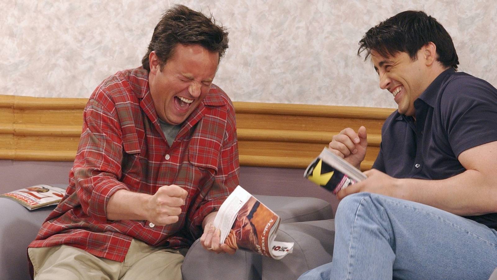 joey-and-chandler-laugh-hysterically-while-holding-magazines-in-a-waiting-room-on-friends.jpg