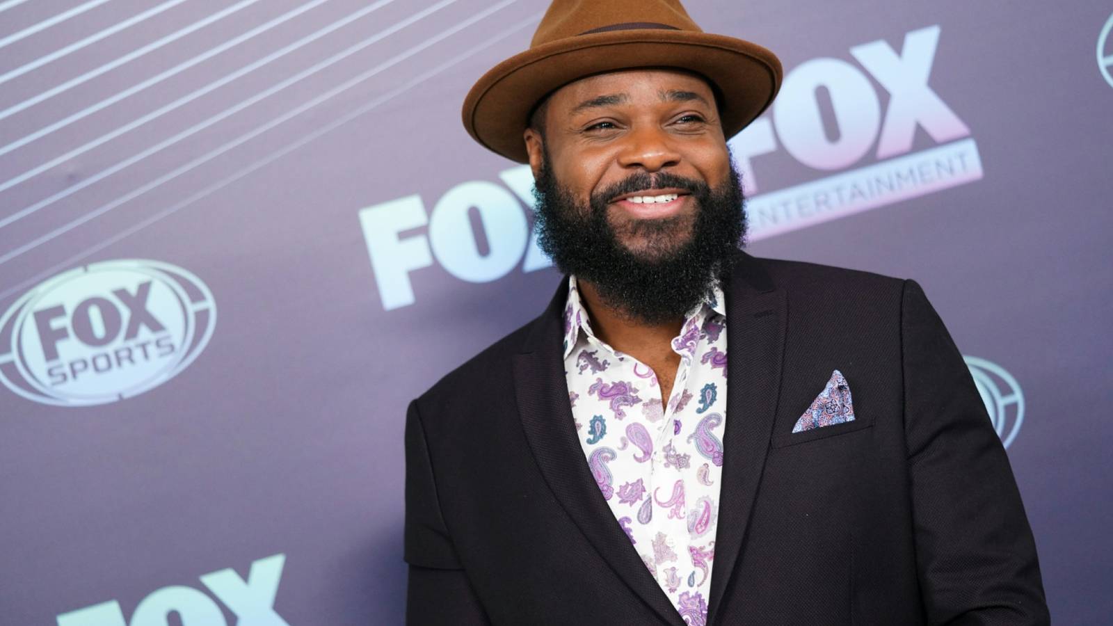 malcolm-jamal-warner-smiling-at-a-fox-event.jpg