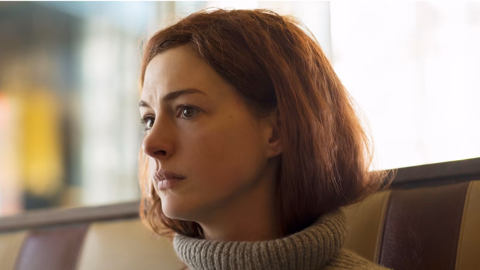 anne-hathaway-looking-sad-in-a-booth-in-modern-love.jpg