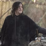 daryl-wearing-a-poncho-next-to-a-motorcycle-in-the-walking-dead-daryl-dixon-season-3-episode-6.jpg